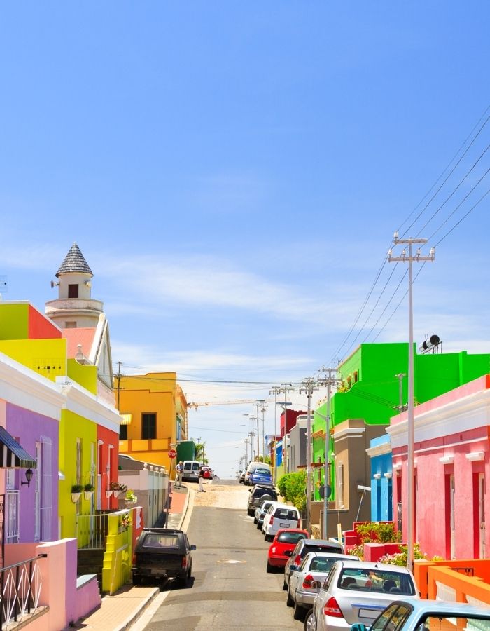Travelers walking through historic and cultural bo-kaap neighborhoods of Cape Town during a guided Roots & Routes tour