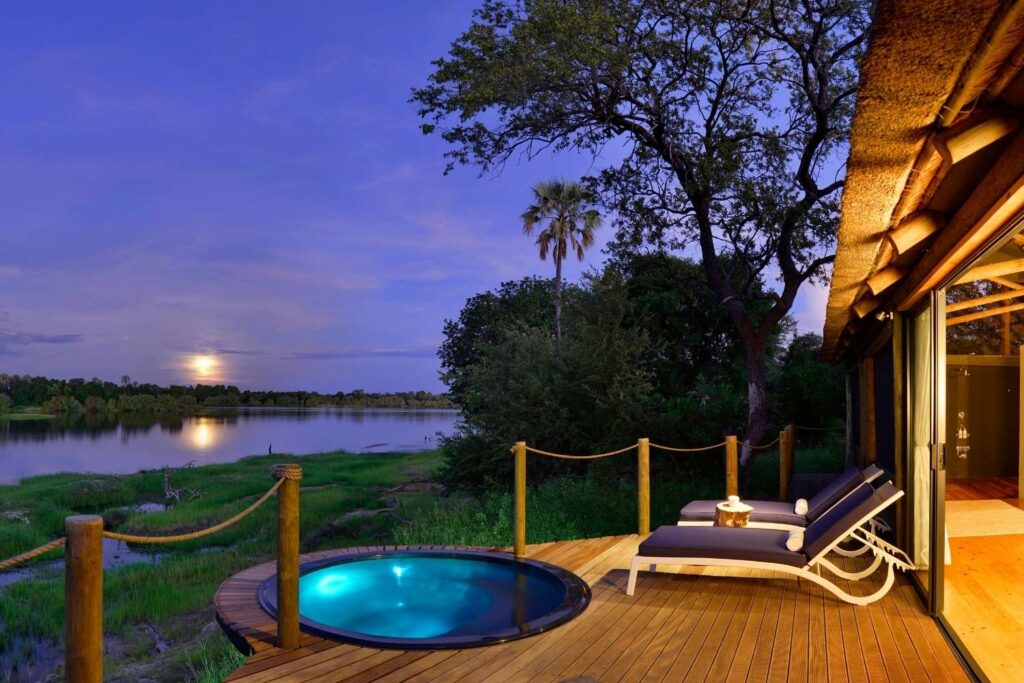 Luxury safari lodge pool in the African wilderness at sunset